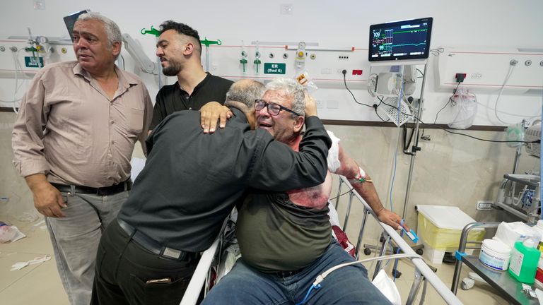 An injured journalist is being hugged by one of the colleagues of killed journalist Shireen Abu Akleh. Pic: AP