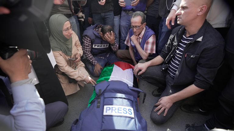 Journalists surround the body of Shireen Abu Akleh. Pic: AP
