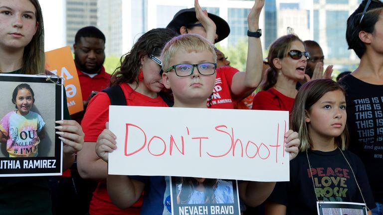 Children hold placards and pictures of victims of the Uvalde, Texas school shooting during a protest at Discovery Green Park, across from the National Rifle Association's Annual Meeting held in George R. Brown Convention Center on Friday, May 27, 2022, in Houston.  (AP Photo / Michael Wyke)