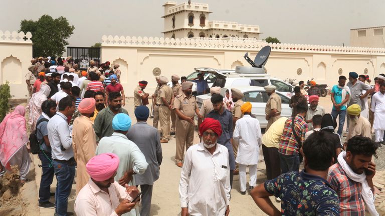 Villagers gather outside the residence of Shubhdeep Singh Sidhu, also known around the world by his stage name Sidhu Moose Wala, in Musa village, near in Mansa, Punjab state, India, Monday, May 30, 2022. Indian police are investigating the killing of the popular Punjabi rapper, who blended hip-hop, rap and folk music, a day after he was fatally shot. (AP Photo)