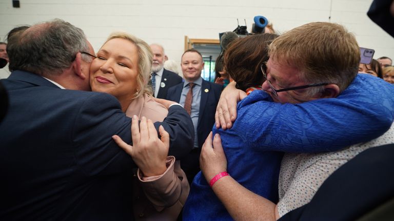 Sinn Fein leader Mary Lou McDonald (R) and Michelle O&#39;Neill (L) are hugged by wellwishers as they arrive at the Northern Ireland Assembly Election count centre at Meadowbank Sports arena in Magherafelt