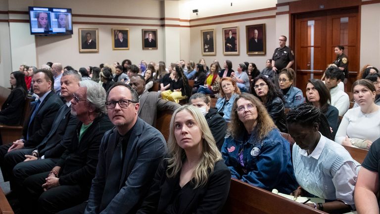 Spectators in court look at monitors in the courtroom in the Fairfax County Circuit Courthouse in Fairfax, Va., Thursday, May 26, 2022. Actor Johnny Depp sued his ex-wife Amber Heard for libel in Fairfax County Circuit Court after she wrote an op-ed piece in The Washington Post in 2018 referring to herself as a 