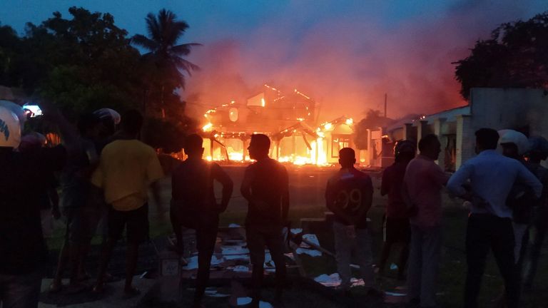 Anti-government demonstrators set fire on the house owned by minister Sanath Nishantha of resigned Prime Minister Mahinda Rajapaksa&#39;s cabinet after ruling party supporters stormed anti-govt protest camp, amid the country&#39;s economic crisis, in Arachchikattuwa, Sri Lanka, April May 9, 2022. REUTERS/Stringer NO ARCHIVES NO RESALES
