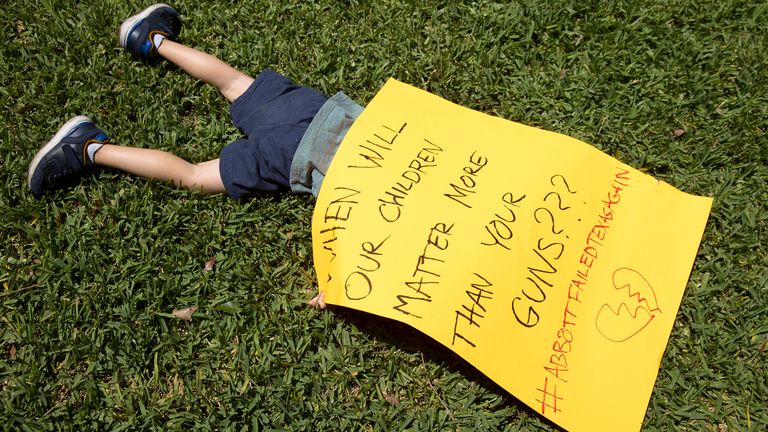 Remy Ragsdale, 3, attends a protest organized by Moms Demand Action Wednesday, May 25, 2022 at the Governor's Mansion in Austin, Texas after a mass shooting at an elementary school in Uvalde.  (Jay Janner/Austin American-Statesman via AP)