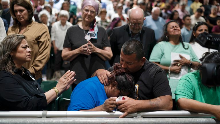 Two family members of one of the victims at a vigil. Pic: AP