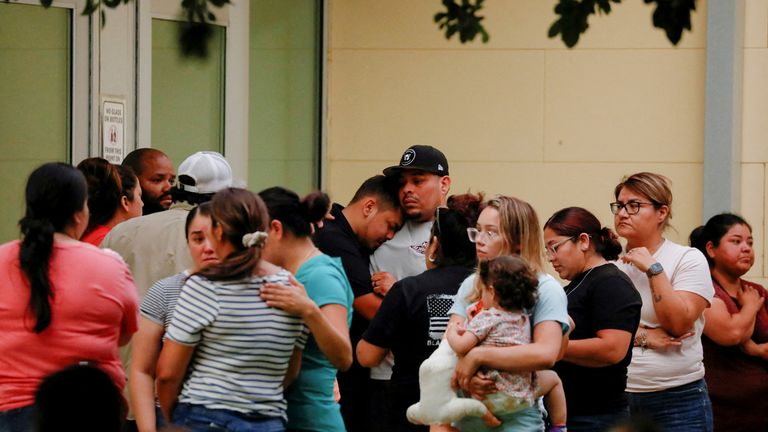 People react outside the Ssgt Willie de Leon Civic Center, where students were transported from Robb Elementary School after a shooting, in Uvalde, Texas, U.S., May 24, 2022. REUTERS/Marco Bello REFILE - QUALITY REPEAT