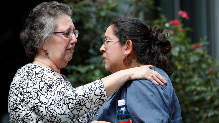 Women react outside the Ssgt Willie de Leon Civic Center, where students had been transported from Robb Elementary School after the shooting