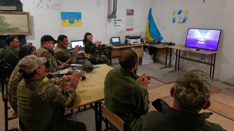 Ukrainian service members watch the performance of Kalush Orchestra from Ukraine during the final of the 2022 Eurovision Song Contest, as Russia&#39;s attack on Ukraine continues, at their position in Kyiv region, Ukraine May 14, 2022. REUTERS/Valentyn Ogirenko