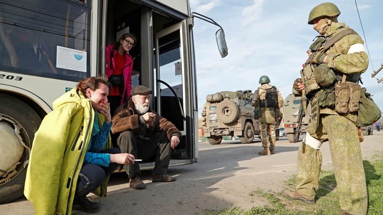 Civilians who left the area near Azovstal pictured with pro-Russian troops in Bezimenne, about 18  miles east of Mariupol
