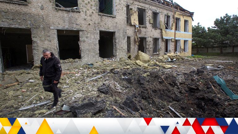 A police officer walks next to a school building damaged by a Russian military strike, as Russia&#39;s attack on Ukraine continues, in the settlement of Kostiantynivka, in Donetsk region, Ukraine May 22, 2022. Picture taken May 22, 2022.  REUTERS/Anna Kudriavtseva