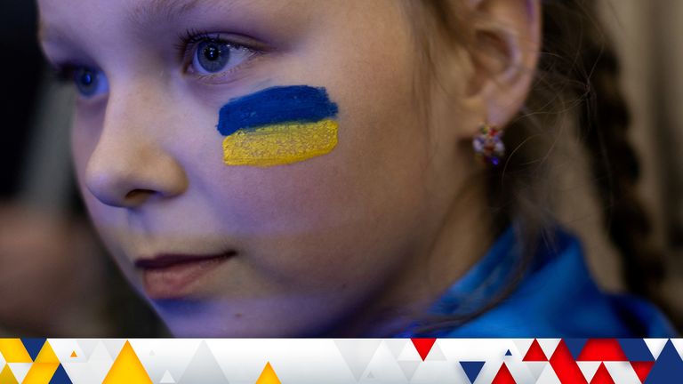 An Ukrainian girl with the national flag painted on her face, attends a cultural event in support of Ukraine organised in a metro station, amid Russia&#39;s invasion of Ukraine, in Dnipro, Ukraine May 14, 2022. Picture taken May 14, 2022