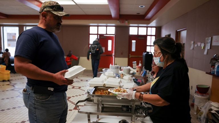 Volunteers give free meals to individuals who were forced to evacuate their homes due the wildfire
