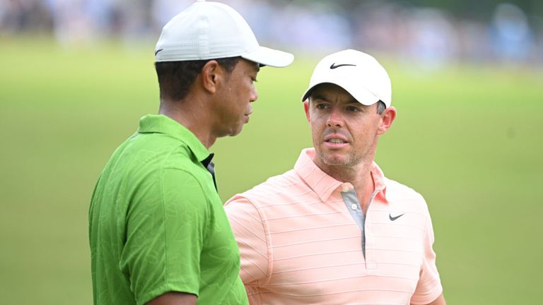 Rory McIlroy speaks to Tiger Woods during the second round of the PGA Championship