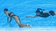 A member of Team USA (R) recovers USA&#39;s Anita Alvarez (L), from the bottom of the pool during an incendent in the women&#39;s solo free artistic swimming finals, during the Budapest 2022 World Aquatics Championships at the Alfred Hajos Swimming Complex in Budapest on June 22, 2022. (Photo by Oli SCARFF / AFP) (Photo by OLI SCARFF/AFP via Getty Images)