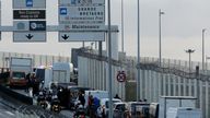 Cars and truck are stopped as French fishermen block the entrance of the Euro Tunnel, in Coquelles, northern France Friday, Nov. 26, 2021. French fishing crews are threatening to block French ports and traffic under the English Channel on Friday to disrupt the flow of goods to the U.K., in a dispute over post-Brexit fishing licenses. (AP Photo/Michel Spingler)