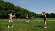 Francesco Ruvolo and Penny Salman play a badminton-style game, as a heat wave reaches the UK, in Cambridge