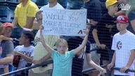 Jean Parks, 12, holds up a sign trying to get the attention of Cincinnati Reds first baseman Joey Votto in Arizona. Pic: Bally Sports Ohio