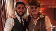 Johnny Depp (right) with a member of staff during his visit to curry house Varanasi in Birmingham