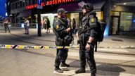 Security forces stand at the site where several people were injured during a shooting outside the London pub in central Oslo, Norway June 25, 2022
