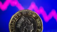 A British pound coin is seen in front of displayed stock graph in this illustration taken, November 9, 2021. REUTERS/Dado Ruvic/Illustration