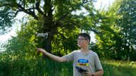 Andriy Pokrasa, 15, lands his drone on his hand during an interview with The Associated Press in Kyiv, Ukraine, Saturday, June 11, 2022. Andriy is being hailed in Ukraine for stealthy aerial reconnaissance work he has done with his dad in the ongoing war with Russia. They used their drone to help the country&#39;s military spot, locate and destroy Russian targets in the early days of the Russian invasion. (AP Photo/Natacha Pisarenko)