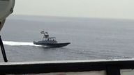 In this image from a video made available by the U.S. Navy, a boat of Iran's Islamic Revolutionary Guard Corps Navy (IRGCN) operates in close proximity to patrol coastal ship USS Sirocco (PC 6) and expeditionary fast transport USNS Choctaw County (T-EPF 2) in the Strait of Hormuz, Monday, June 20, 2022. A U.S. Navy warship fired a warning flare to wave off an Iranian Revolutionary Guard speedboat coming straight at it during a tense encounter in the strategic Strait of Hormuz, officials said Tuesday. (U.S. Navy via AP)
