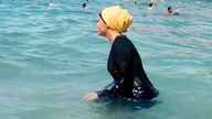 A woman wears a burkini in the water. Pic: AP