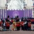Security alert as protesters wearing plastic crowns jump barriers and run out in front of guardsmen