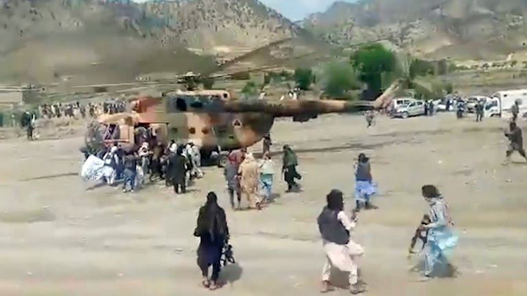 Taliban fighters secure a government helicopter to evacuate injured people in Gayan district, Paktika province, Afghanistan. Pic: Afghan government news agency via AP