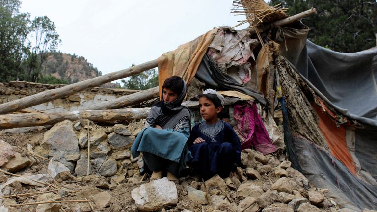 Two boys sit near their house that was destroyed in the earthquake in Khost Province, Afghanistan