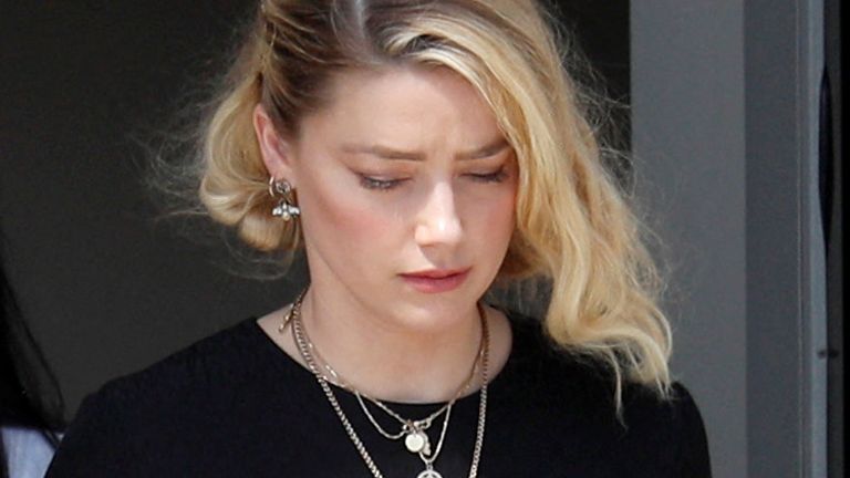 Amber Heard leaves court after her ex-husband, Johnny Depp, wins his libel case against her