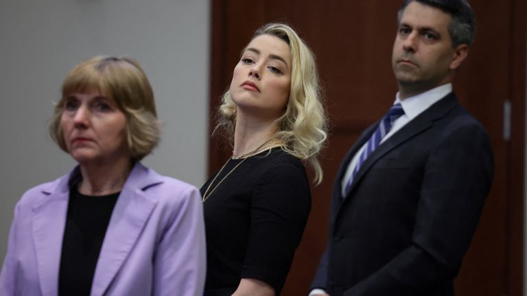 Actor Amber Heard and her attorneys Elaine Bredehoft and Benjamin Rottenborn look over to the jury, just before the jury announced that they believe she defamed ex-husband Johnny Depp while announcing split verdicts in favor of both her ex-husband Johnny Depp and Heard on their claim and counter-claim in the Depp v. Heard civil defamation trial at the Fairfax County Circuit Courthouse in Fairfax, Virginia, U.S., June 1, 2022. REUTERS/Evelyn Hockstein/Pool
