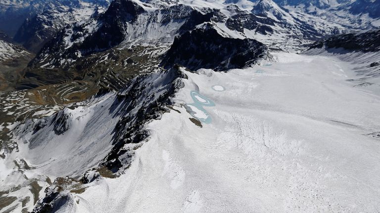 An aerial view of Olivares glacier in the Andes Mountain range, near Santiago city, Chile November 17, 2014. Higher air temperatures have meant snow in the Andes, once a key store of meltwater for spring and summer, is not compacting, melts faster, or turns straight to vapour. Picture taken November 17, 2014. REUTERS/Ivan Alvarado/File Photo SEARCH "DROUGHT PENUELAS" FOR THIS STORY. SEARCH "WIDER IMAGE" FOR ALL STORIES