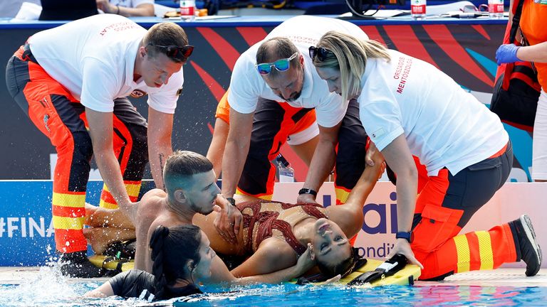 Alvarez receives medical attention after being resuced from the pool