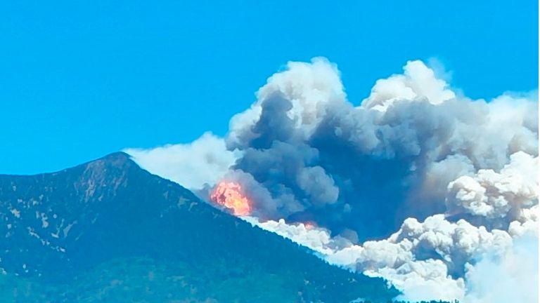 A wildfire burns on the outskirts of Flagstaff, Ariz, on Monday, June 13, 2022. Hundreds of homes have been evacuated because of the wildfire. Pic: Jacob Hyden via AP