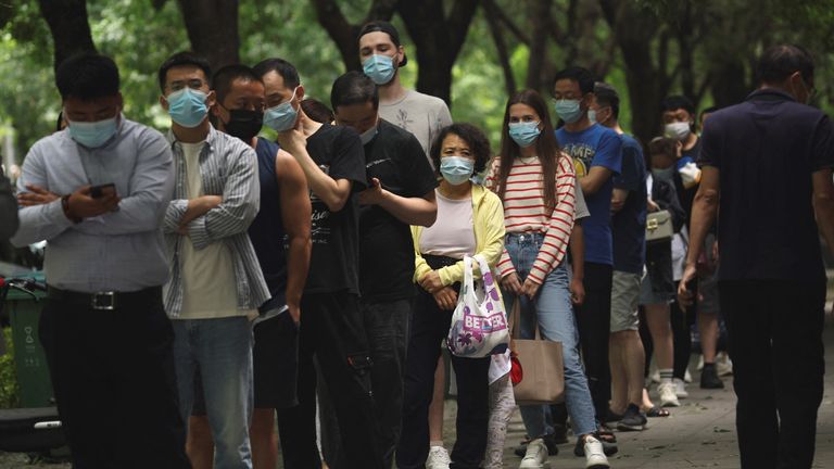 13 Haziran 2022'de Çin'in başkenti Pekin'de koronavirüs hastalığı (COVID-19) salgınının ardından insanlar bir mobil test kabininde nükleik asit testleri için sıraya giriyor. REUTERS/Tingshu Wang