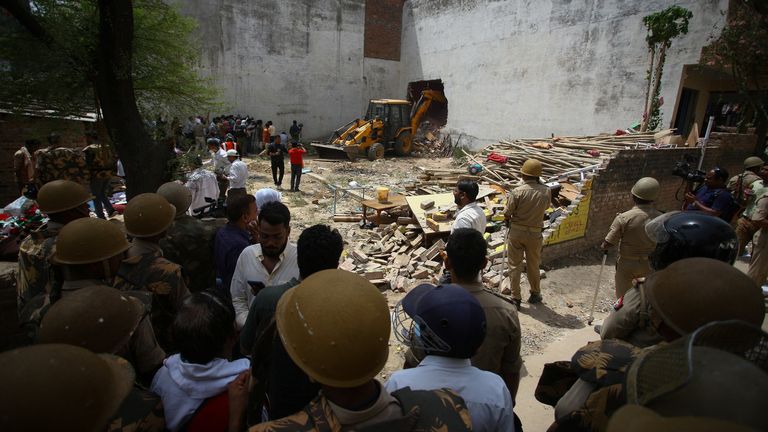 A bulldozer demolishes the house of a Muslim man that Uttar Pradesh state authorities accuse of being involved in riots last week, that erupted following comments about the Prophet Mohammed by India&#39;s ruling Bharatiya Janata Party (BJP) members, in Prayagraj, India, June 12, 2022. Authorities claim the house was illegally built. REUTERS/Ritesh Shukla
