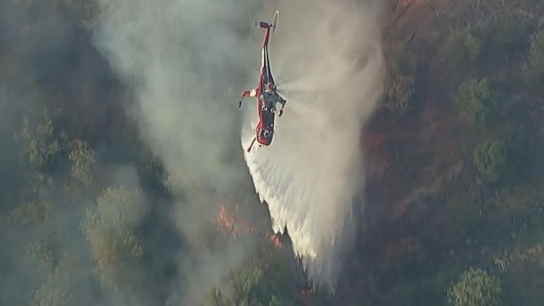 Firefighters work to contain a wild blaze near Hesperia in California