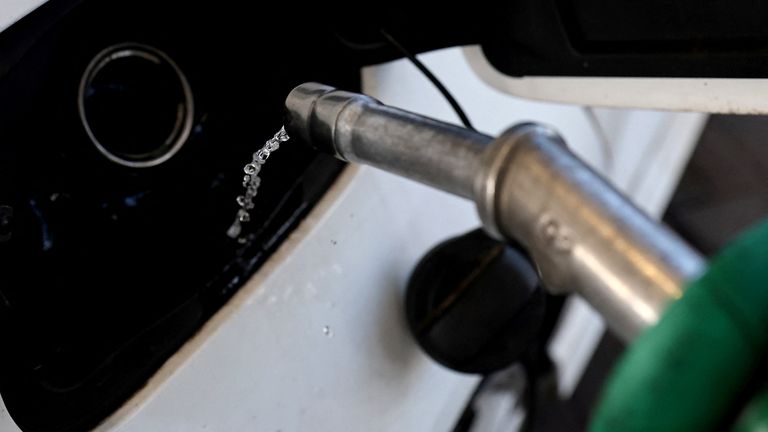 FILE PHOTO: A car is filled with petrol at a filling station, in Knutsford, Cheshire, Britain, March 10, 2022. REUTERS/Carl Recine/File Photo