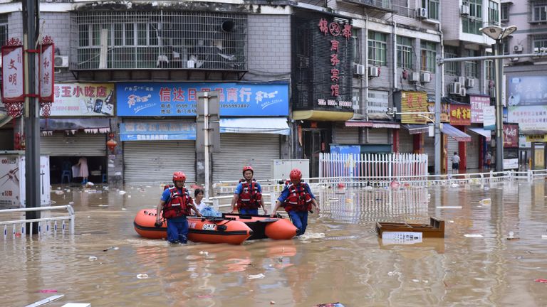 Rescuers evacuate people stranded after flooding caused by heavy rain in the city of Jian&#39;ou in southeast China.