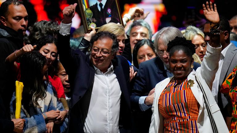 Former rebel Gustavo Petro and his running mate Francia Marquez, celebrate before supporters after winning a runoff presidential election in Bogota, Colombia, Sunday, June 19, 2022. (AP Photo/Fernando Vergara)