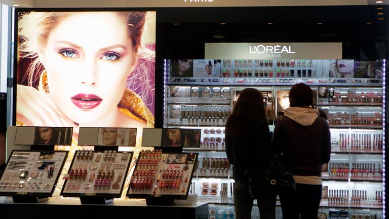 People look at L&#39;Oreal cosmetics in a shop in Riga April 13, 2012