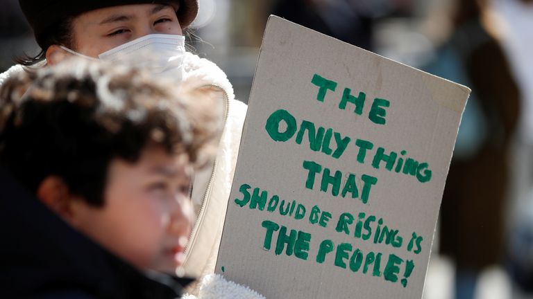 A person holds a sign during a protest about the rising cost of living during a demonstration outside Downing Street in London, Britain, April 2, 2022. REUTERS/Peter Nicholls