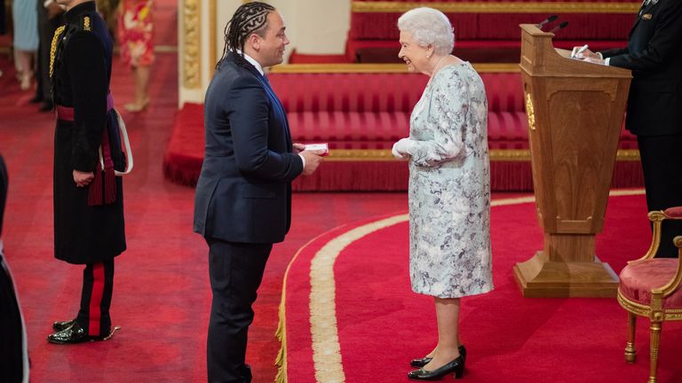 Alex Holmes gets his Young leaders award. Pic: HM The Queen and British Ceremonial Arts Limited