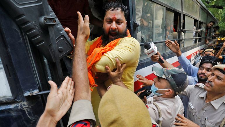 An activist of Bajrang Dal, a Hindu hardline group, reacted after he was detained by police during a protest against the killing of a Hindu man in the city of Udaipur. a day after two Muslim men posted a video claiming responsibility for his murder, in New Delhi, India, June 29, 2022. REUTERS/Amit Dave