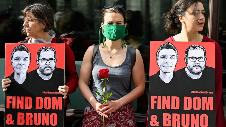 Protesters hold banners and roses as they protest after the disappearance, in the Amazon, of journalist Dom Phillips and campaigner Bruno Araujo Pereira, outside the Brazilian Embassy in London, Britain, June 9, 2022. REUTERS / Toby Melville