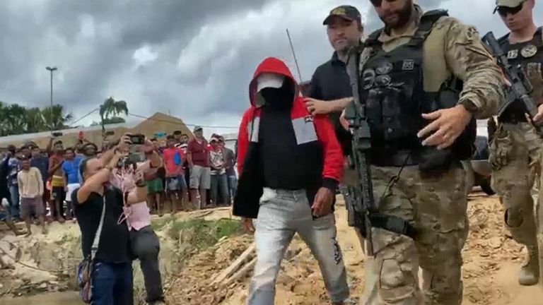 Hooded and masked suspect in Dom Phillips disappearance is led away by police in Brazil