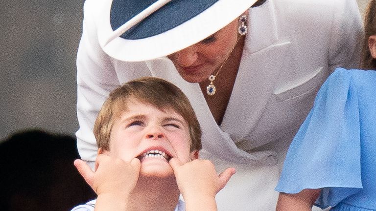 The Duchess of Cambridge talks to Prince Louis as he pulls his face across the balcony of Buckingham Palace, to watch the Platinum Year celebrations, on day one of the Platinum Year celebrations.  Date taken: Thursday, June 2, 2022.