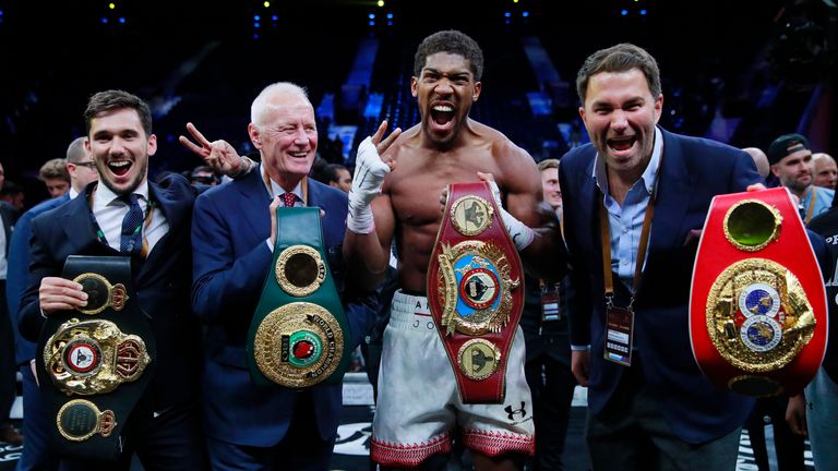 Boxing - Andy Ruiz Jr v Anthony Joshua - IBF, WBA, WBO & IBO World Heavyweight Titles - Diriyah Arena, Diriyah, Saudi Arabia - December 7, 2019. Anthony Joshua celebrates victory in the bout against Andy Ruiz Jr against promoters Eddie Hearn and Barry Hearn.  Action images via Reuters / Andrew Couldridge