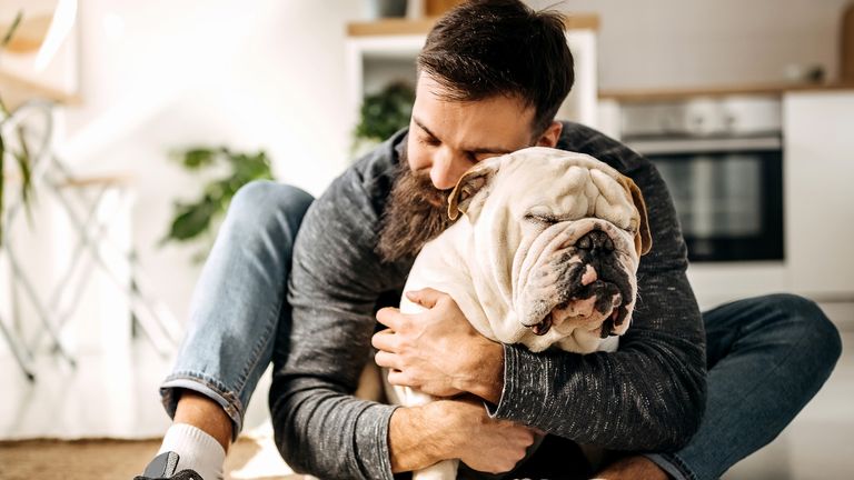 Young bearded man bonding with his english bulldog
CreditIStock